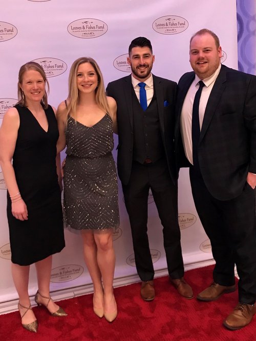 Four employees at a gala event