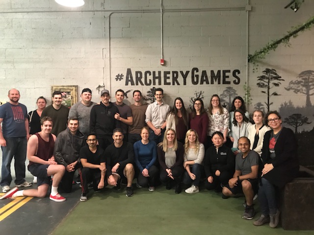 Staff posing at an archery event