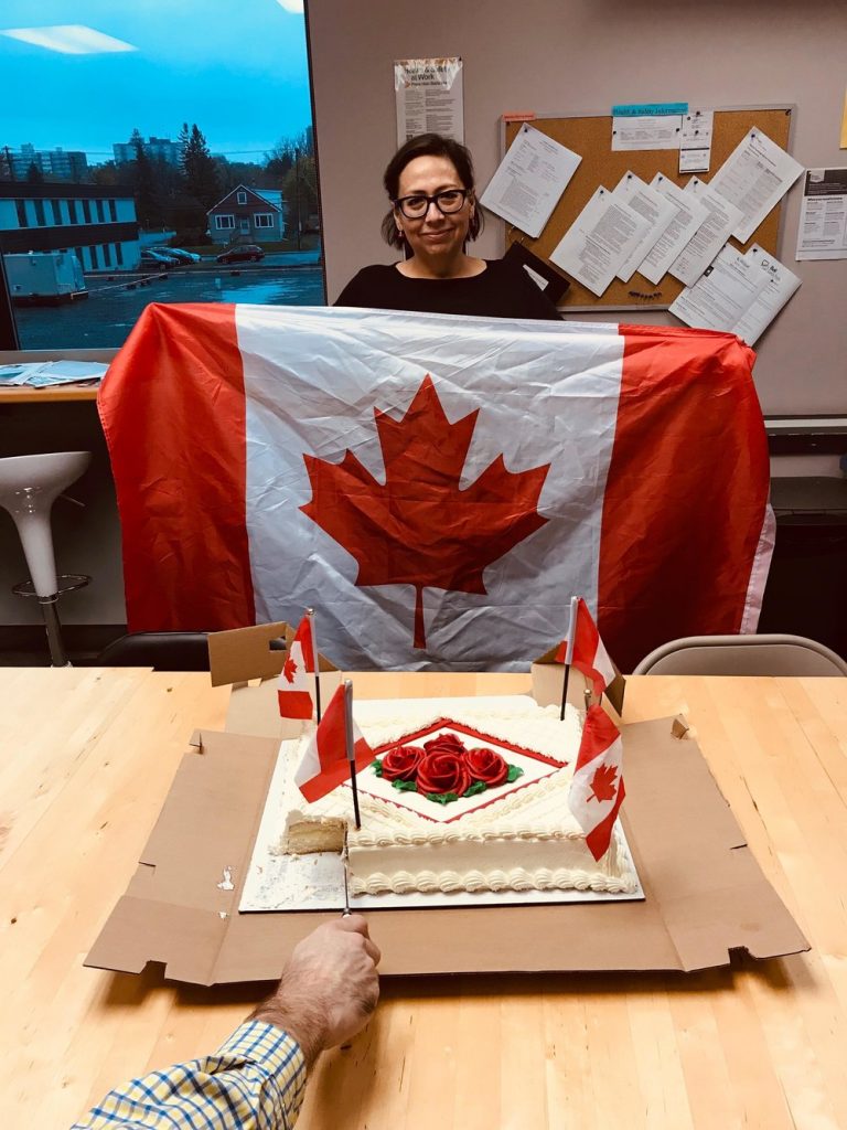 Hendry Warren staff holding a Canadian flag