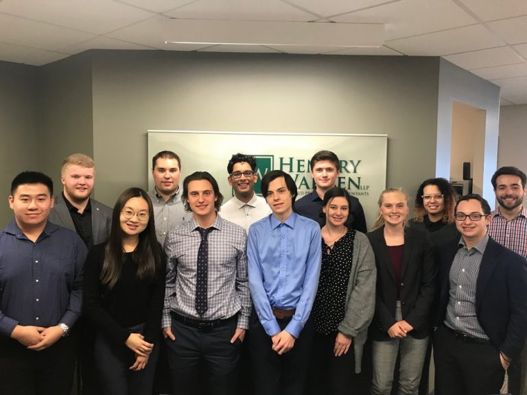 Thirteen Hendry Warren Employees standing in the office