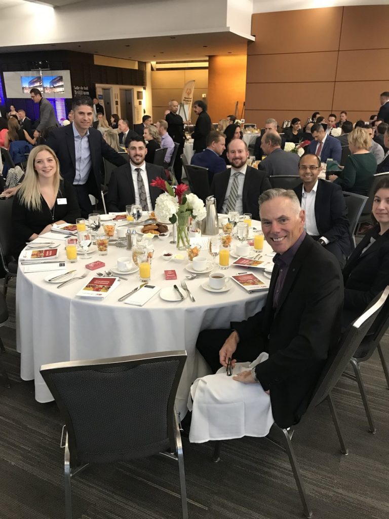 Staff members at a charity breakfast