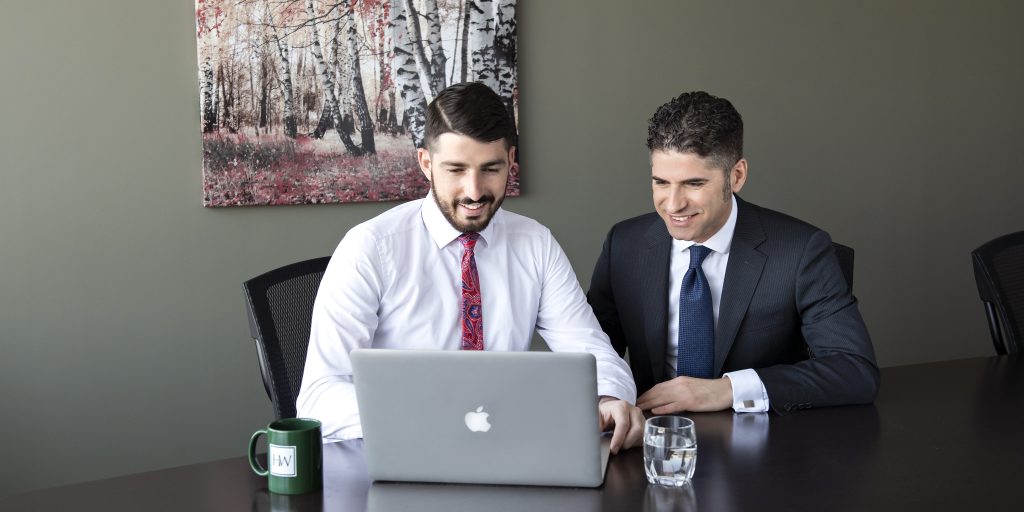 Two employees working together at a computer