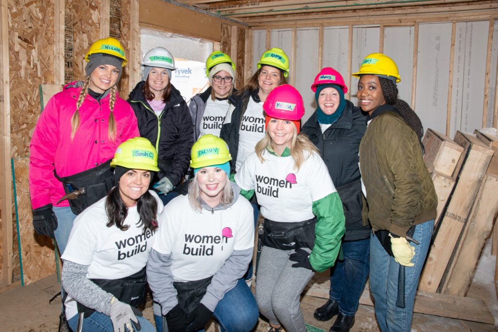 Nine staff members volunteering at a "Women Build" charity event
