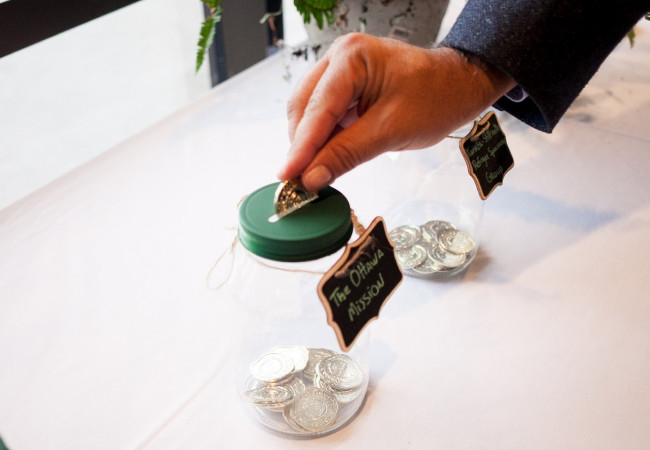 A person putting money into a jar