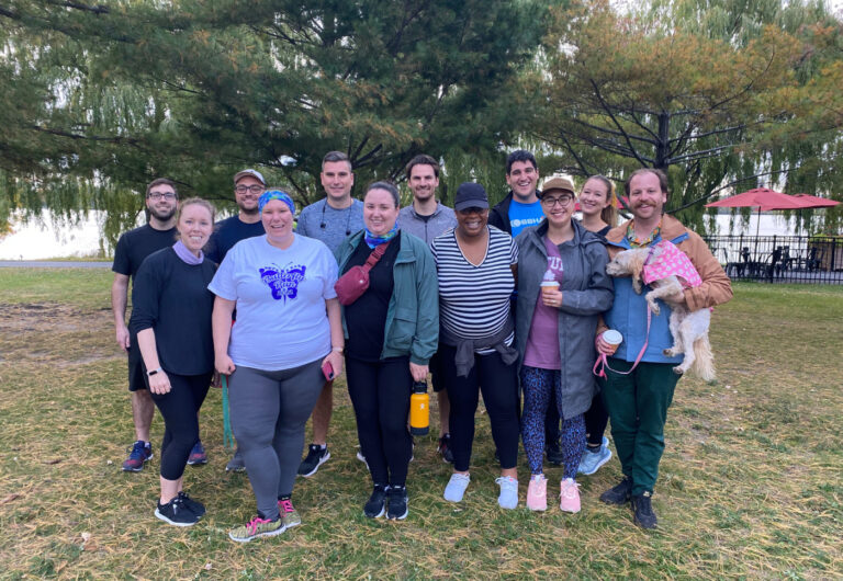 Employees standing outside at a running event