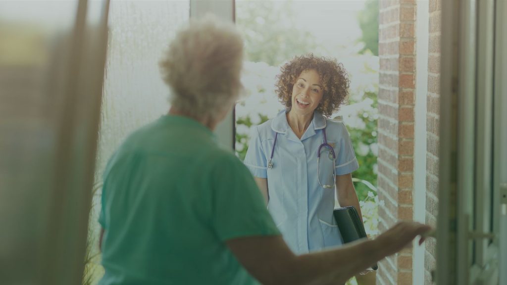 Home-care worker visiting an eldery lady.